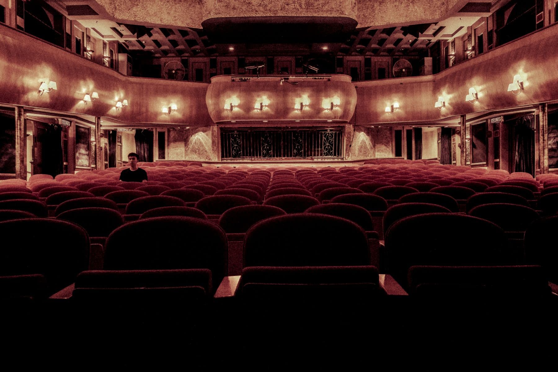 Theatre seats filling for a night show